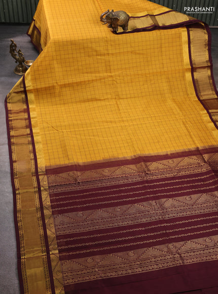 Silk cotton saree mustard yellow and coffee brown with allover checked pattern and temple zari woven korvai border