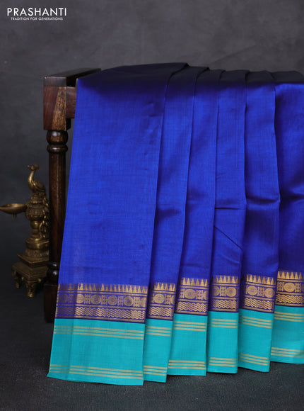 Silk cotton saree blue and teal green with plain body and temple rettapet zari woven korvai border
