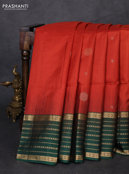 Pure soft silk saree rust shade and bottle green with allover zari woven buttas and zari woven border