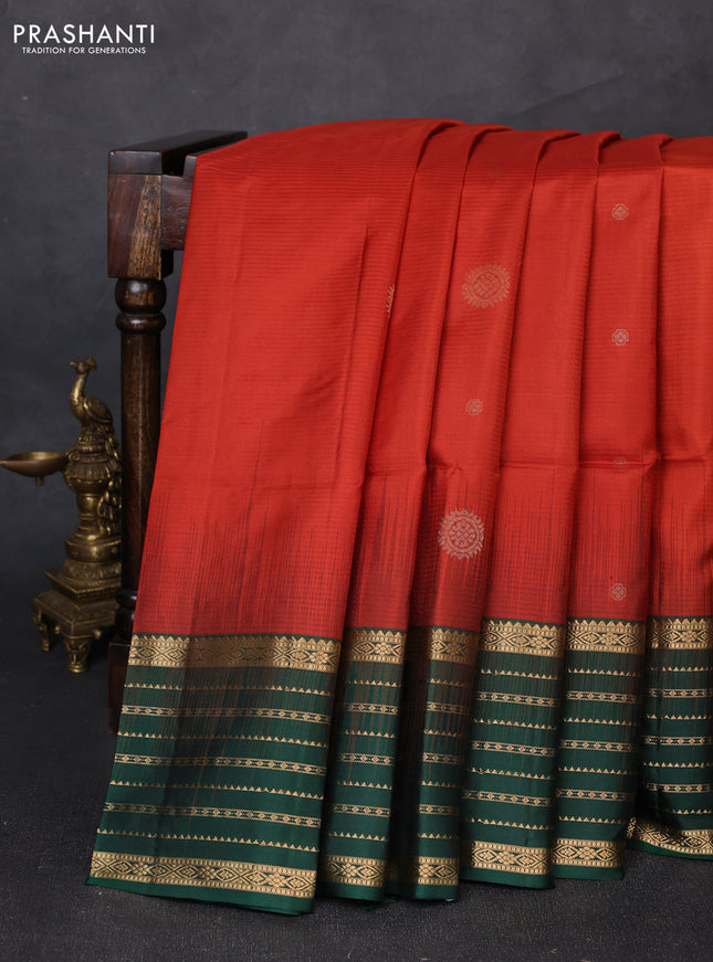 Pure soft silk saree rust shade and bottle green with allover zari woven buttas and zari woven border
