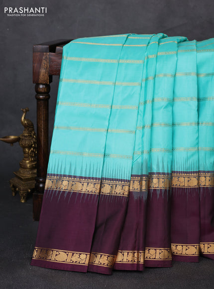 Pure soft silk saree teal blue and deep wine with allover zari weaves pattern and long rettapet zari woven border