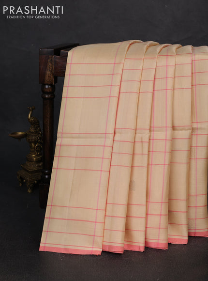 Pure soft silk saree cream and mild peach pink with allover checks & zari buttas and piping border
