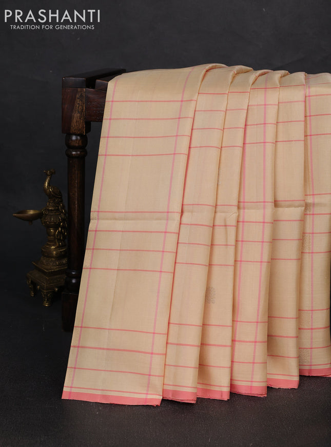 Pure soft silk saree cream and mild peach pink with allover checks & zari buttas and piping border