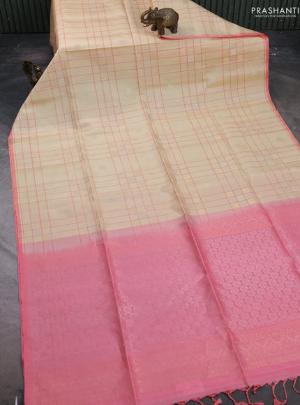 Pure soft silk saree cream and mild peach pink with allover checks & zari buttas and piping border