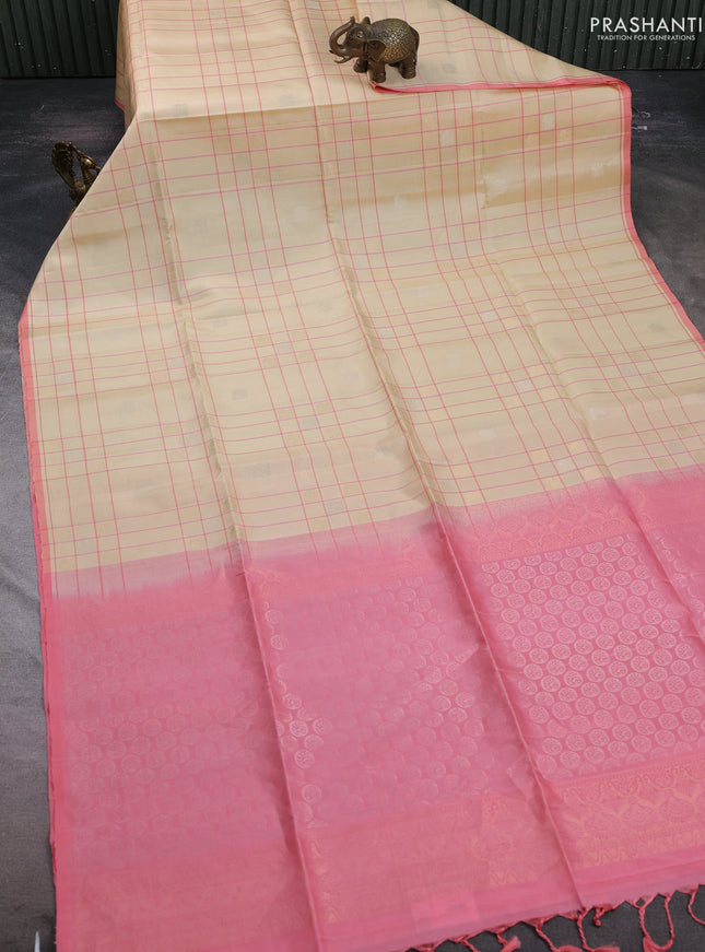 Pure soft silk saree cream and mild peach pink with allover checks & zari buttas and piping border