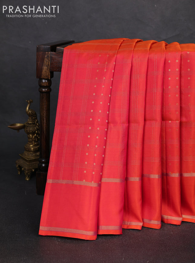 Pure soft silk saree dual shade of pinkish orange with allover zari checks & buttas and rettapet zari woven border
