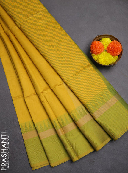 Semi dupion saree mustard yellow and light green with plain body and temple design woven border