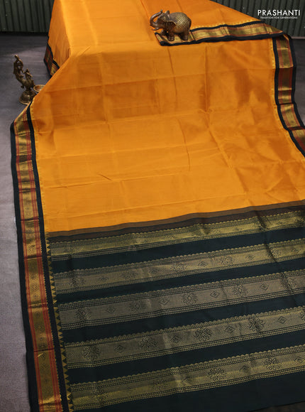 Silk cotton saree dark mustard and bottle green with plain body and zari woven korvai border