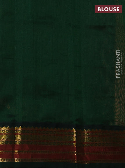 Silk cotton saree pale orange and bottle green with plain body and zari woven korvai border