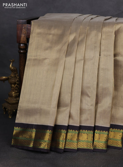 Silk cotton saree pastel green and black with plain body and zari woven korvai border