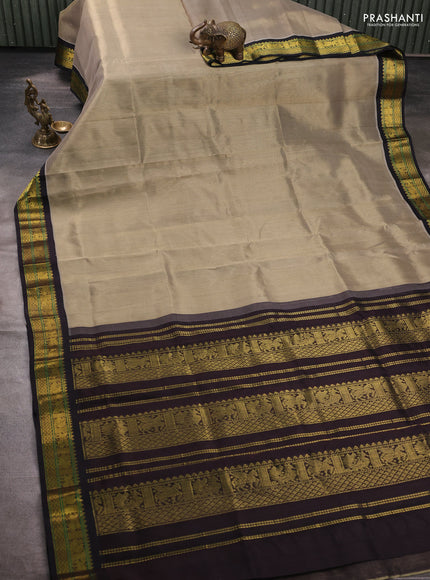 Silk cotton saree pastel green and black with plain body and zari woven korvai border