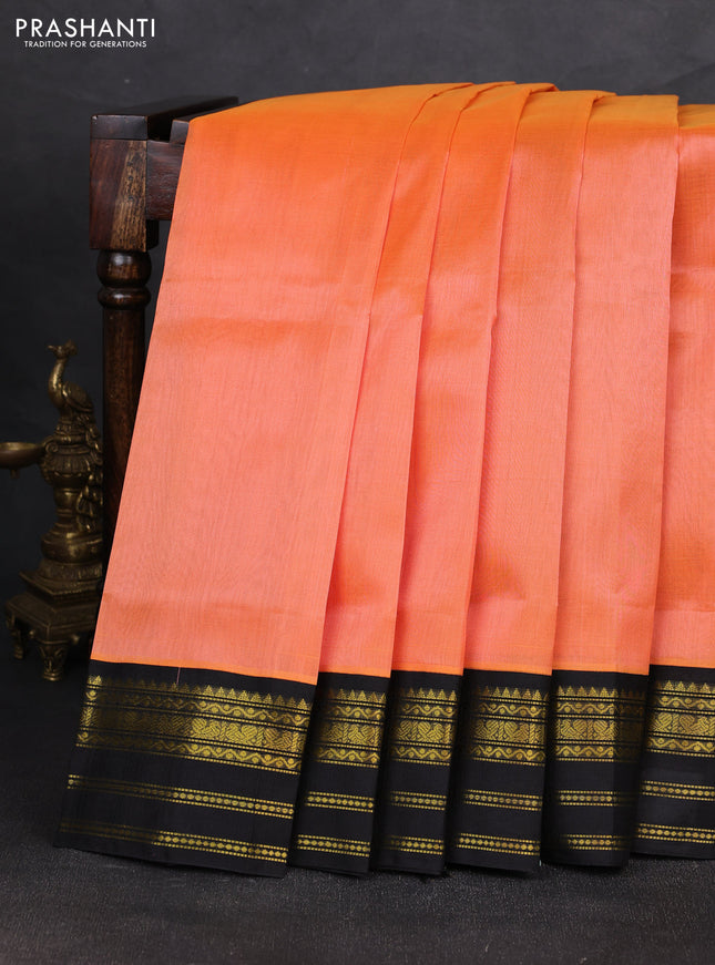 Silk cotton saree peach orange and black with plain body and zari woven korvai border