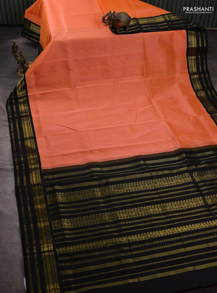 Silk cotton saree peach orange and black with plain body and zari woven korvai border