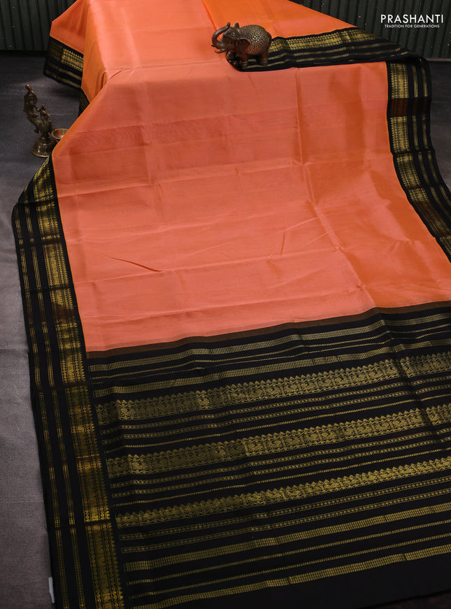 Silk cotton saree peach orange and black with plain body and zari woven korvai border