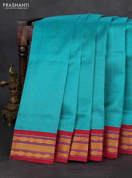Silk cotton saree teal blue and maroon with plain body and zari woven korvai border