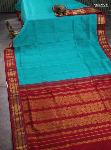 Silk cotton saree teal blue and maroon with plain body and zari woven korvai border