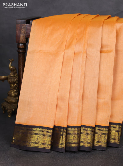 Silk cotton saree peach orange and black with plain body and zari woven korvai border