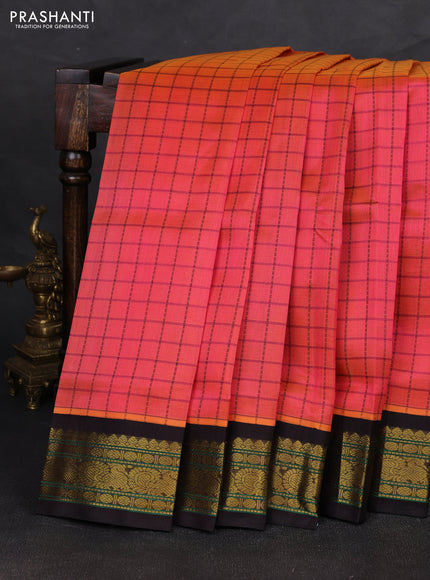 Silk cotton saree dual shade of pinkish orange and black with allover checked pattern and zari woven korvai border