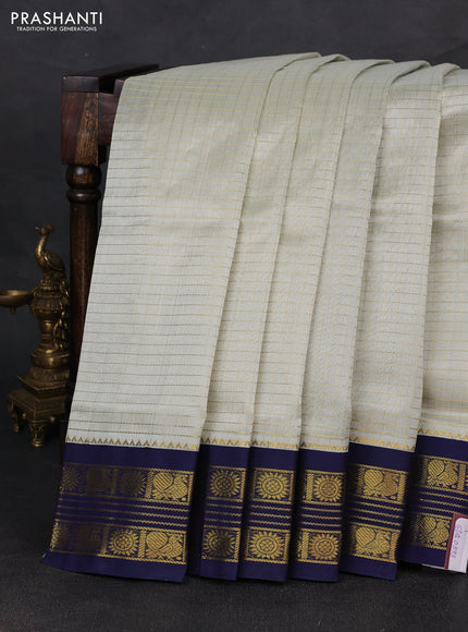 Silk cotton saree mild pista green and navy blue with allover zari checked pattern and zari woven korvai border
