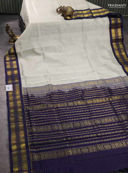 Silk cotton saree mild pista green and navy blue with allover zari checked pattern and zari woven korvai border