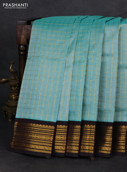 Silk cotton saree pastel blue and black with allover zari checked pattern and zari woven korvai border