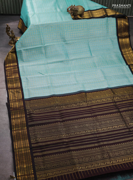 Silk cotton saree pastel blue and black with allover zari checked pattern and zari woven korvai border