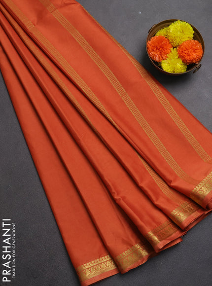 Semi mysore silk saree rustic orange with plain body and small zari woven border