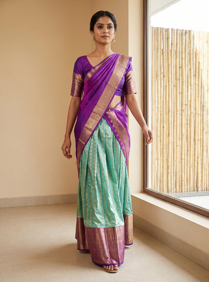 Pure kanchipuram silk lehenga dhawani dual shade of teal and purple with allover zari woven butta weaves and long rich zari woven border