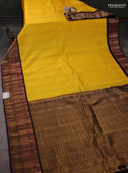 Pure gadwal silk saree yellow and black with allover zari checks & buttas and rich zari woven border