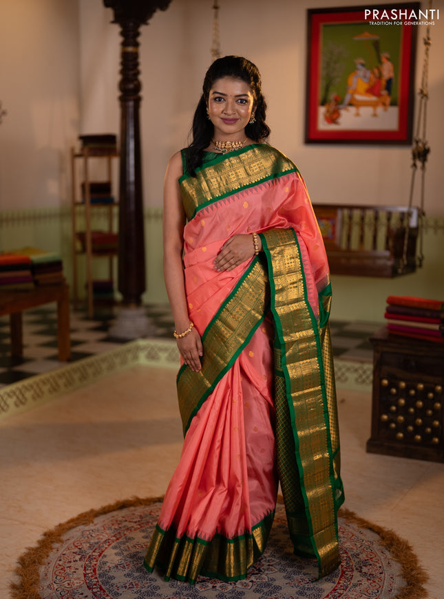 Pure gadwal silk saree peach shade and green with zari woven buttas and temple design zari woven border