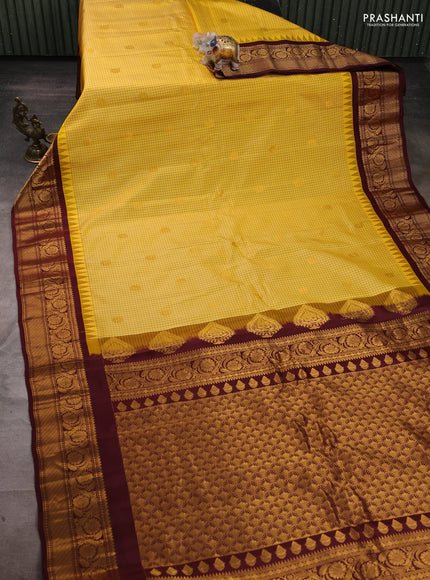 Pure gadwal silk saree yellow and deep maroon with allover checks & zari buttas and temple design zari woven border