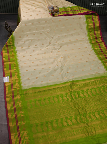 Pure gadwal silk saree cream and light green with paisley zari woven buttas and temple design zari woven border
