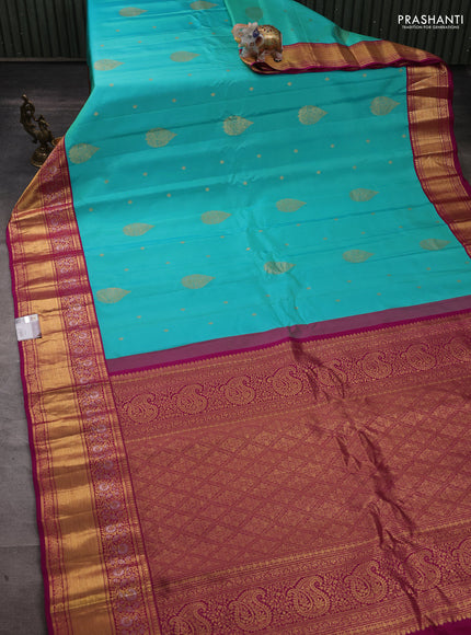 Pure gadwal silk saree dual shade of teal blue and dark magenta pink with zari woven buttas and zari woven border