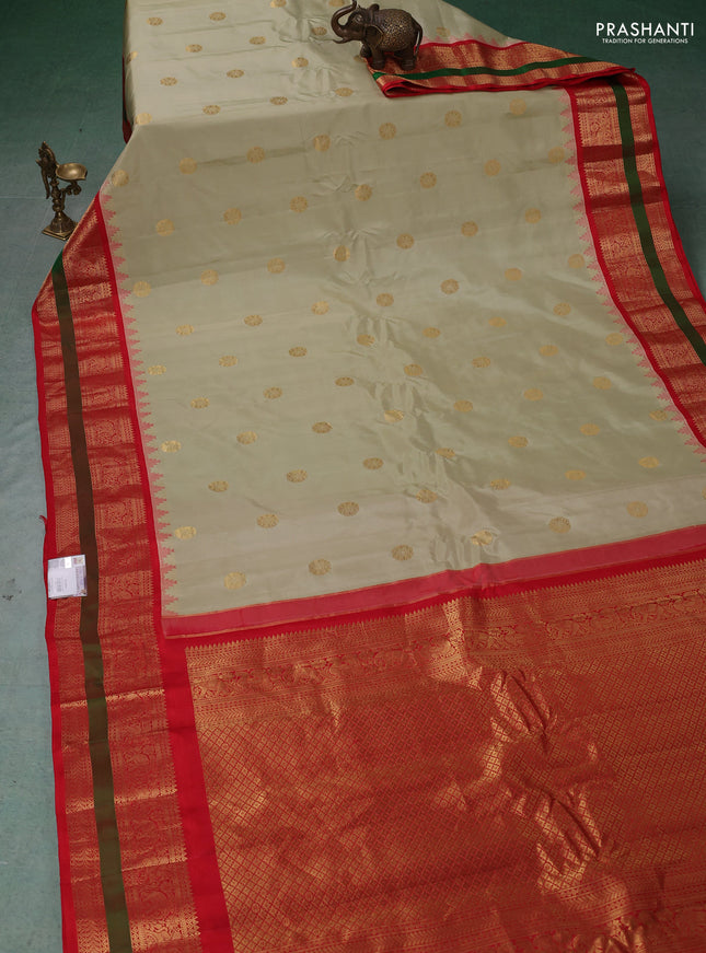 Pure gadwal silk saree mild pista green and orange with zari woven buttas and rettapet zari woven border