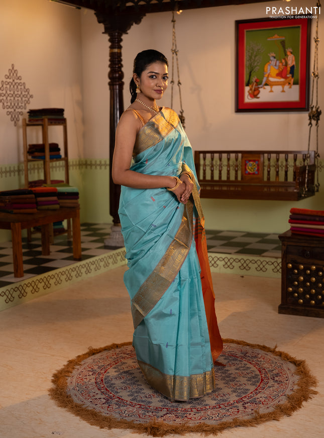 Banana pith saree teal green and rust shade with thread woven buttas and zari woven border