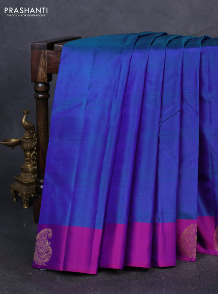 Pure kanchipuram silk saree dual shade of bluish green and purple with plain body and zari woven butta border