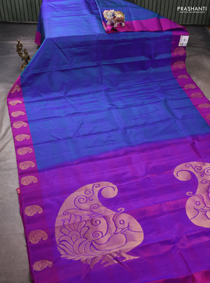 Pure kanchipuram silk saree dual shade of bluish green and purple with plain body and zari woven butta border