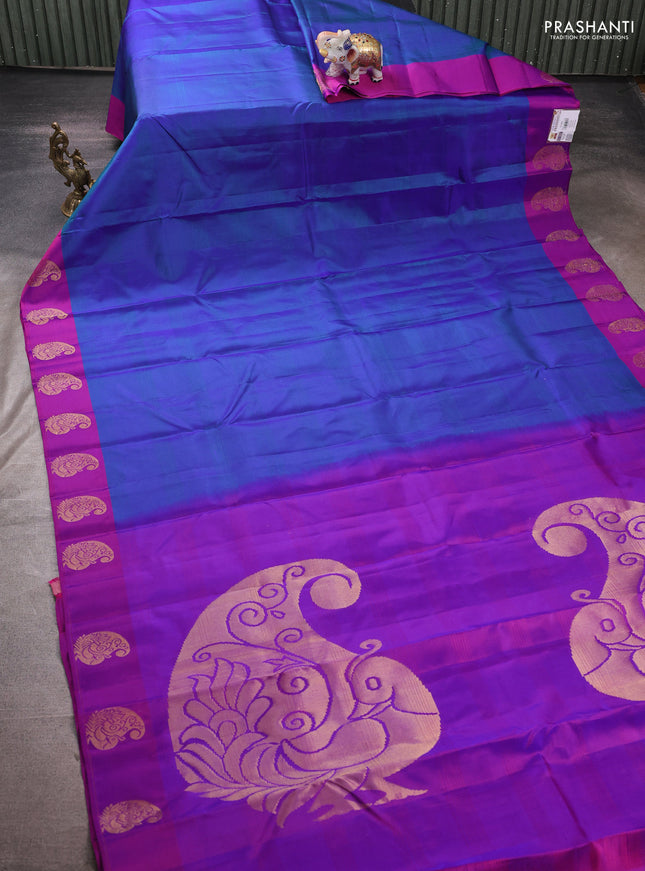 Pure kanchipuram silk saree dual shade of bluish green and purple with plain body and zari woven butta border