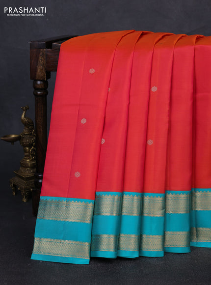 Pure kanchipuram silk saree dual shade of pinkish orange and teal blue with zari woven buttas and rettapet zari woven korvai border