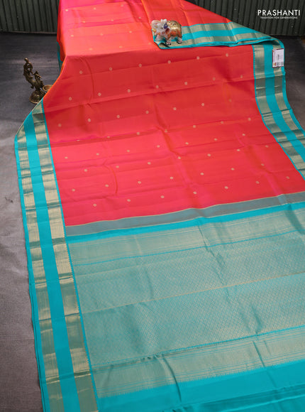Pure kanchipuram silk saree dual shade of pinkish orange and teal blue with zari woven buttas and rettapet zari woven korvai border