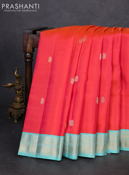 Pure kanchipuram silk saree dual shade od pinkish orange and teal blue with zari woven buttas and zari woven korvai border