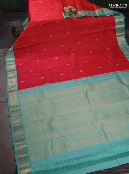 Pure kanchipuram silk saree dual shade od pinkish orange and teal blue with zari woven buttas and zari woven korvai border