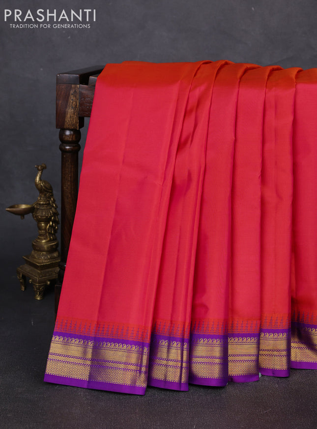 Pure kanchipuram silk saree dual shade od pinkish orange and purple with plain body and temple design zari woven korvai border