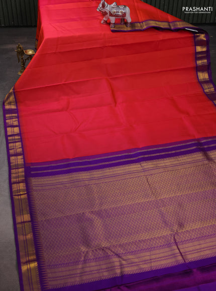 Pure kanchipuram silk saree dual shade od pinkish orange and purple with plain body and temple design zari woven korvai border
