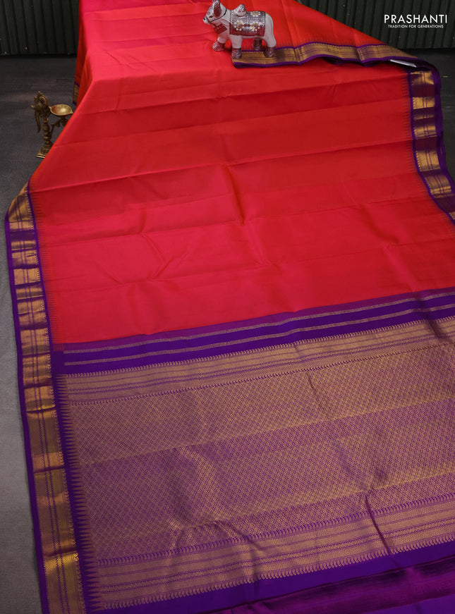 Pure kanchipuram silk saree dual shade od pinkish orange and purple with plain body and temple design zari woven korvai border