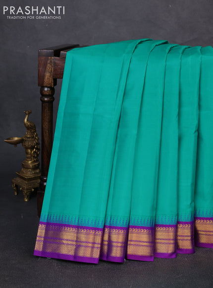Pure kanchipuram silk saree teal blue and purple with plain body and temple design zari woven korvai border