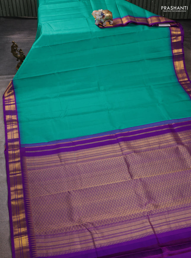 Pure kanchipuram silk saree teal blue and purple with plain body and temple design zari woven korvai border