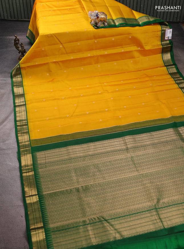 Pure kanchipuram silk saree yellow and green with zari woven buttas and temple design zari woven korvai border