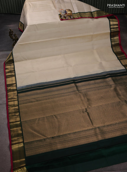 Pure kanchipuram silk saree cream and bottle green with allover zari stripe pattern and zari woven korvai border