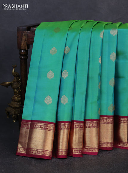 Pure kanchipuram silk saree teal green and dark magenta pink with zari woven buttas and zari woven korvai border